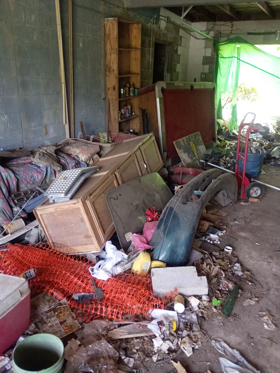 Garage containing unwanted materials before cleanup